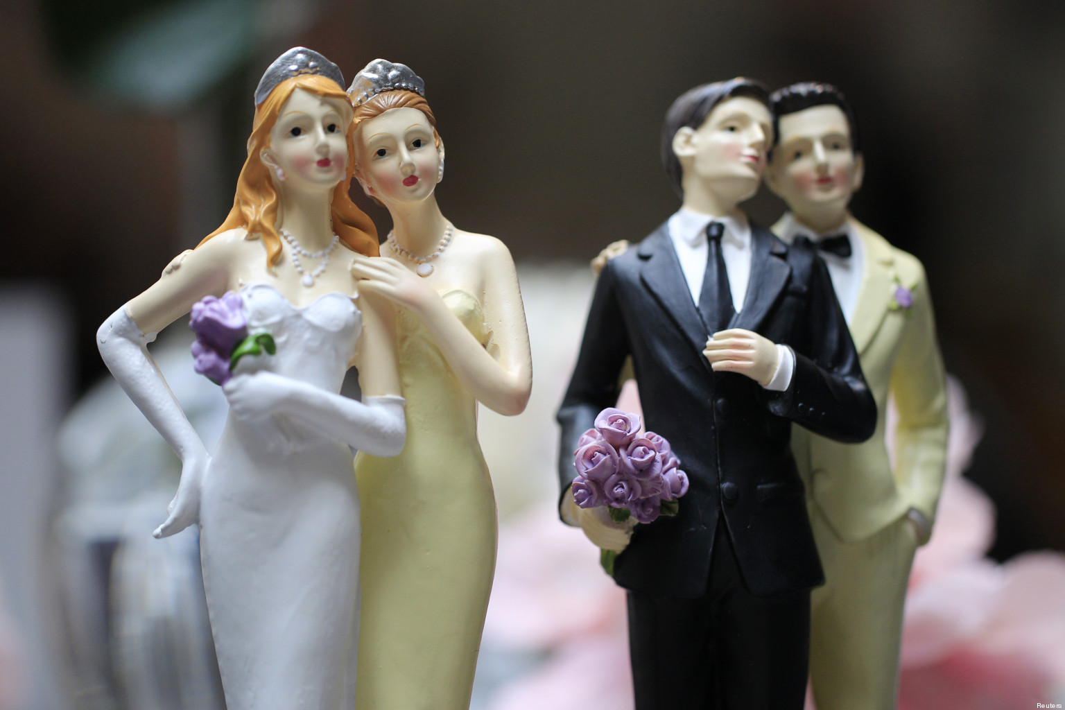 Same-sex couple plastic figurines are displayed during a gay wedding fair in Paris